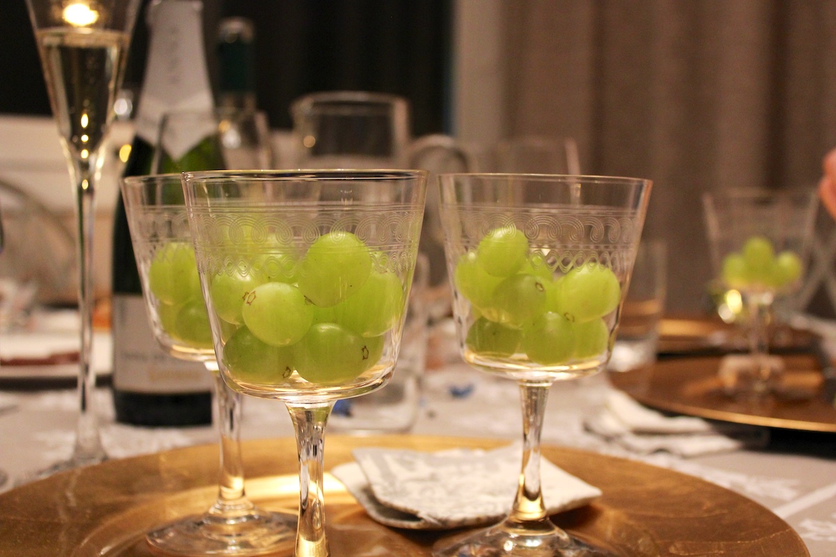 Two small clear goblets of 12 white grapes
