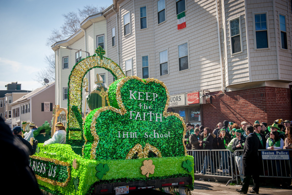 A bright green float in the street during a St. Patrick's Day Parade