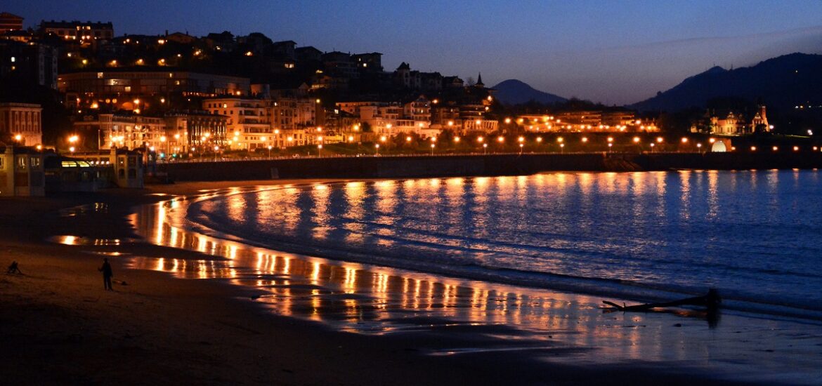 San Sebastian's La Concha beach at night with lights on the water