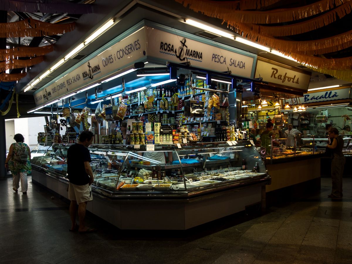 people shopping for edible souvenirs in barcelona at market