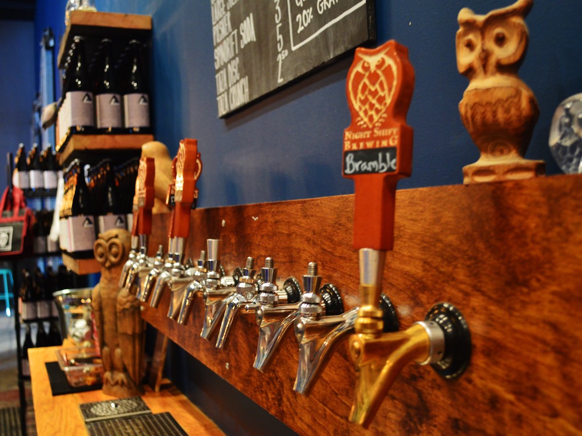 A line of beer taps at a brewery