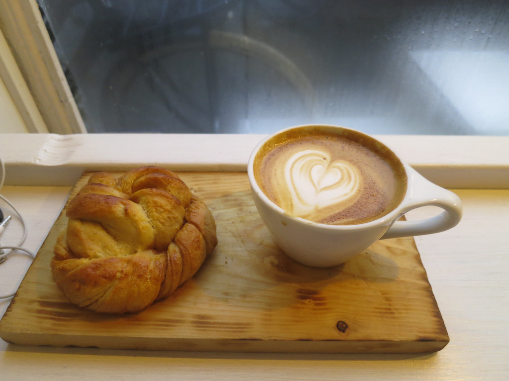 Pastry and coffee in front of a windowsill in a coffee shop or cafe in Amsterdam