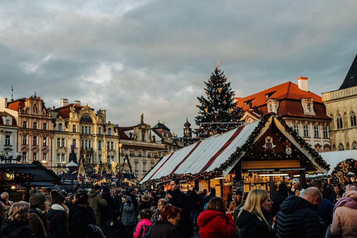 People walking around at a Christmas market buying gourmet gifts in Europe. 