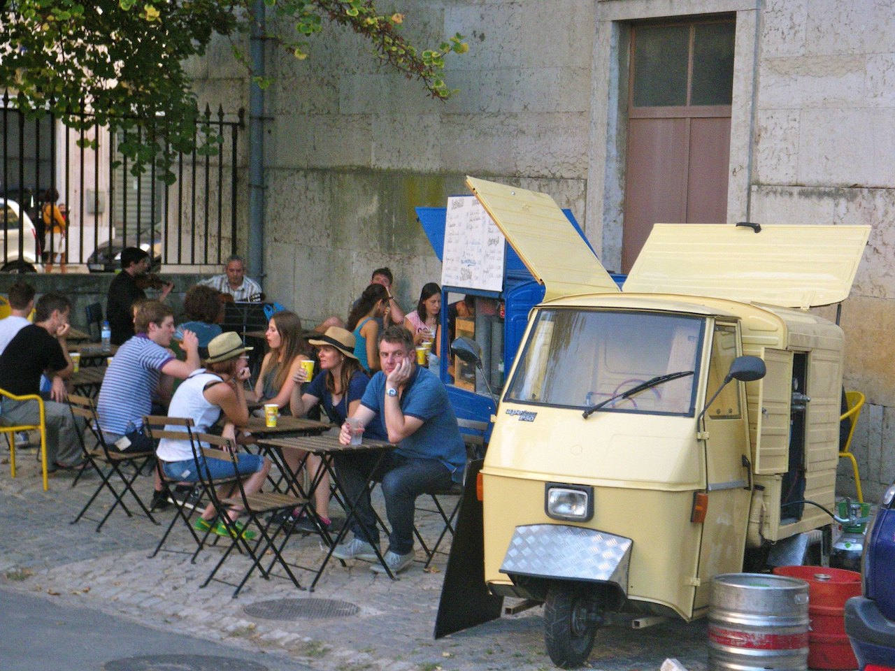 Food truck scene with outdoor diners in Lisbon, Portugal