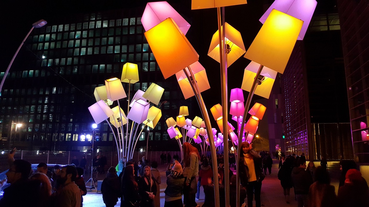 Light display with multicolored, box-shaped lights at the Llum light festival with people below