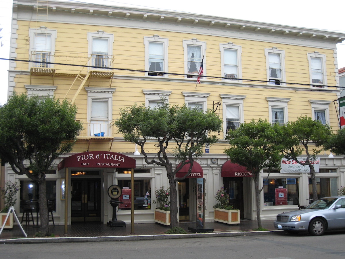 A yellow building with red awnings