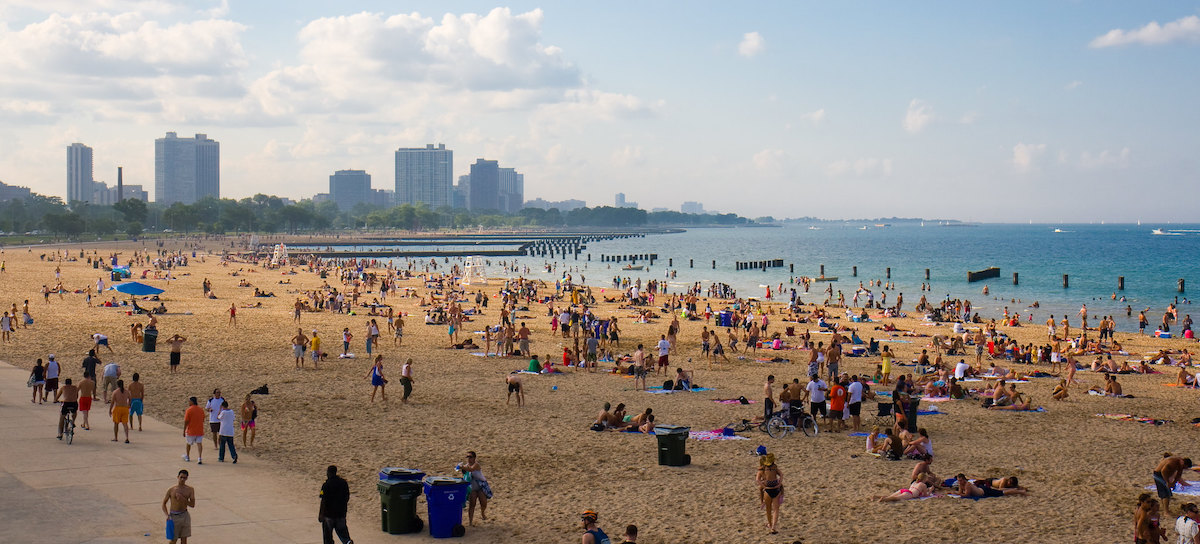 people enjoy the beach with the Chicago skylie in the background