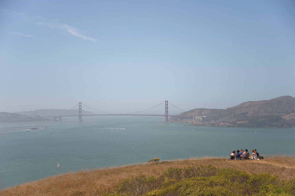 Group enjoys a picnic on a mountain top overlooking the golden gate bridge in San Francisco