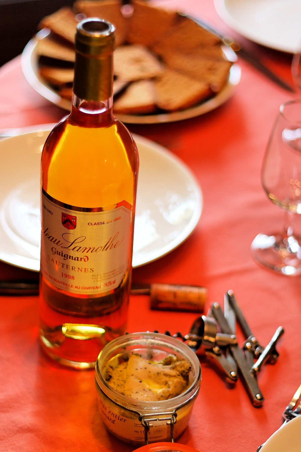 bottle of Sauternes wine on dinner table with foie gras