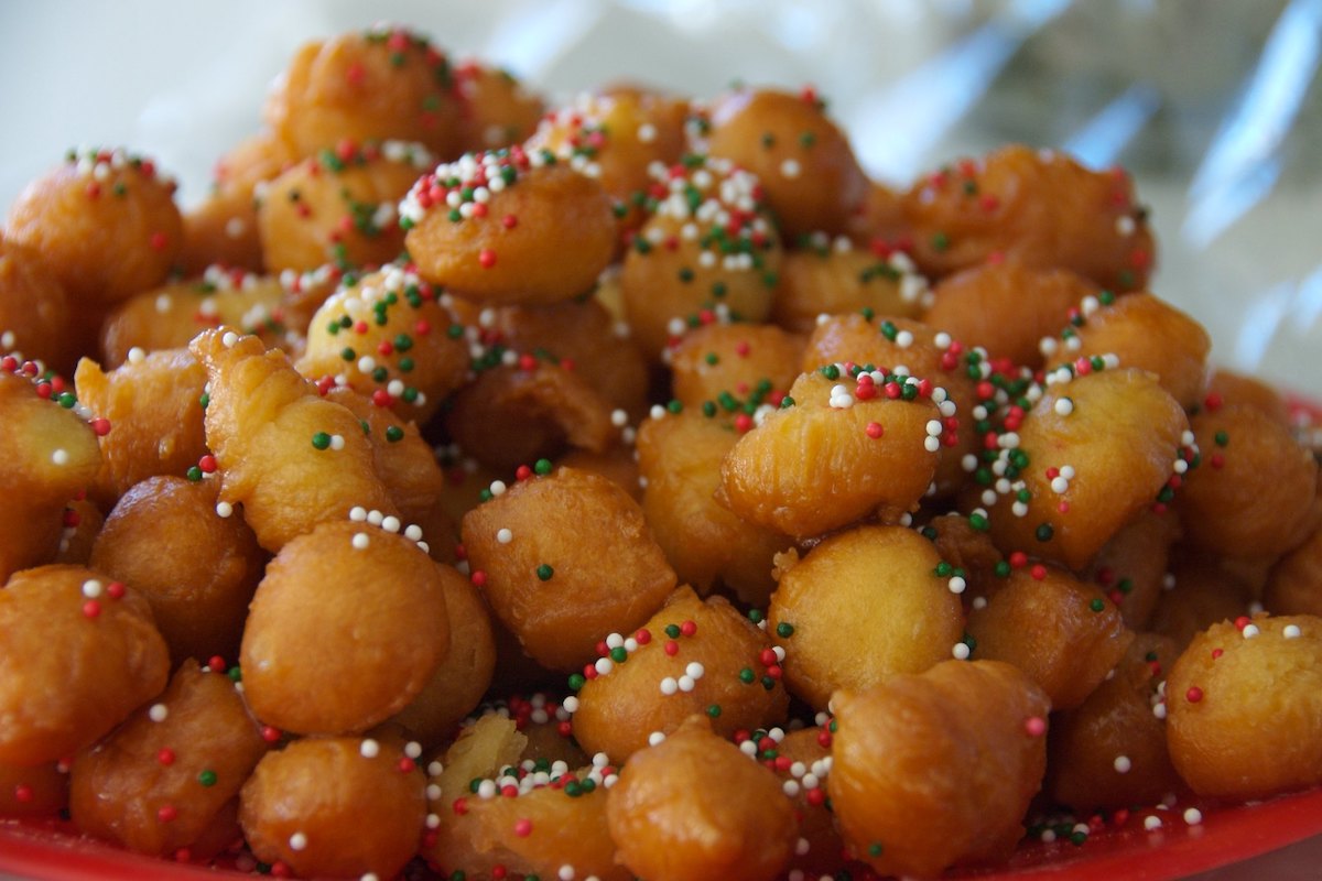 Extreme close up of a plate of struffoli, a Neapolitan pastry typically enjoyed around Christmas