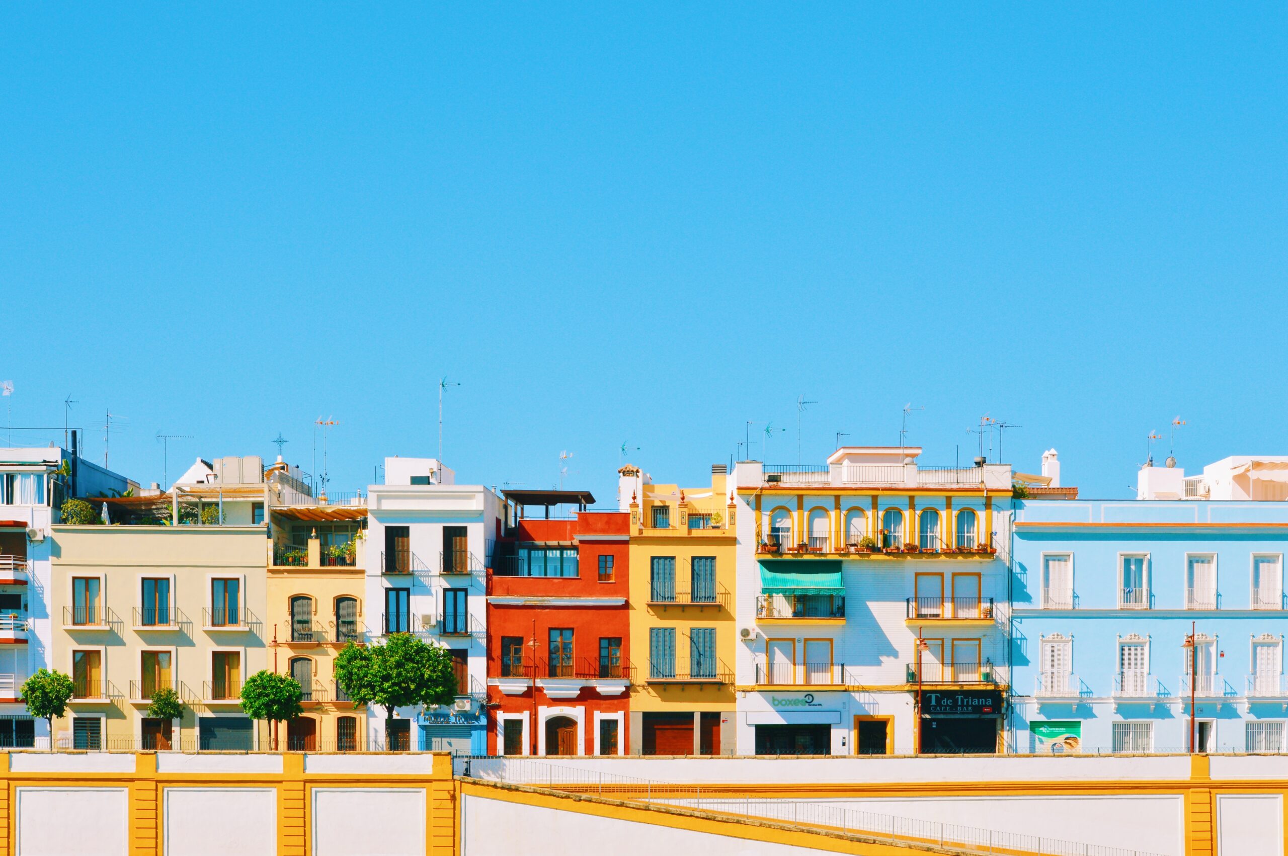 The colorful buildings of Triana and a bright blue sky  