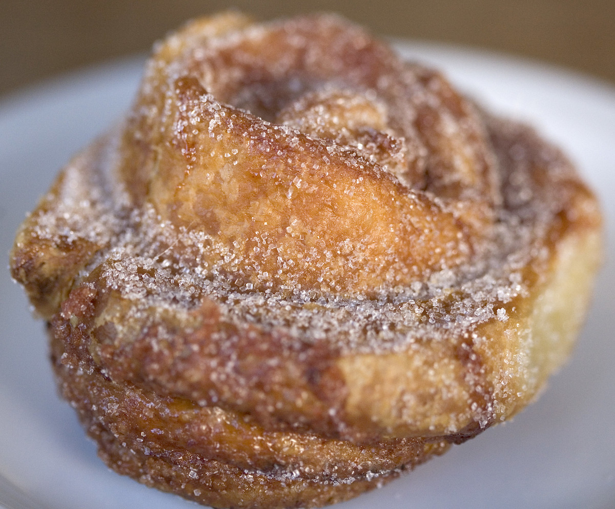 Extreme close up of a cinnamon sugar coated pastry, a morning bun from Tartine Manufactory in San Francisco