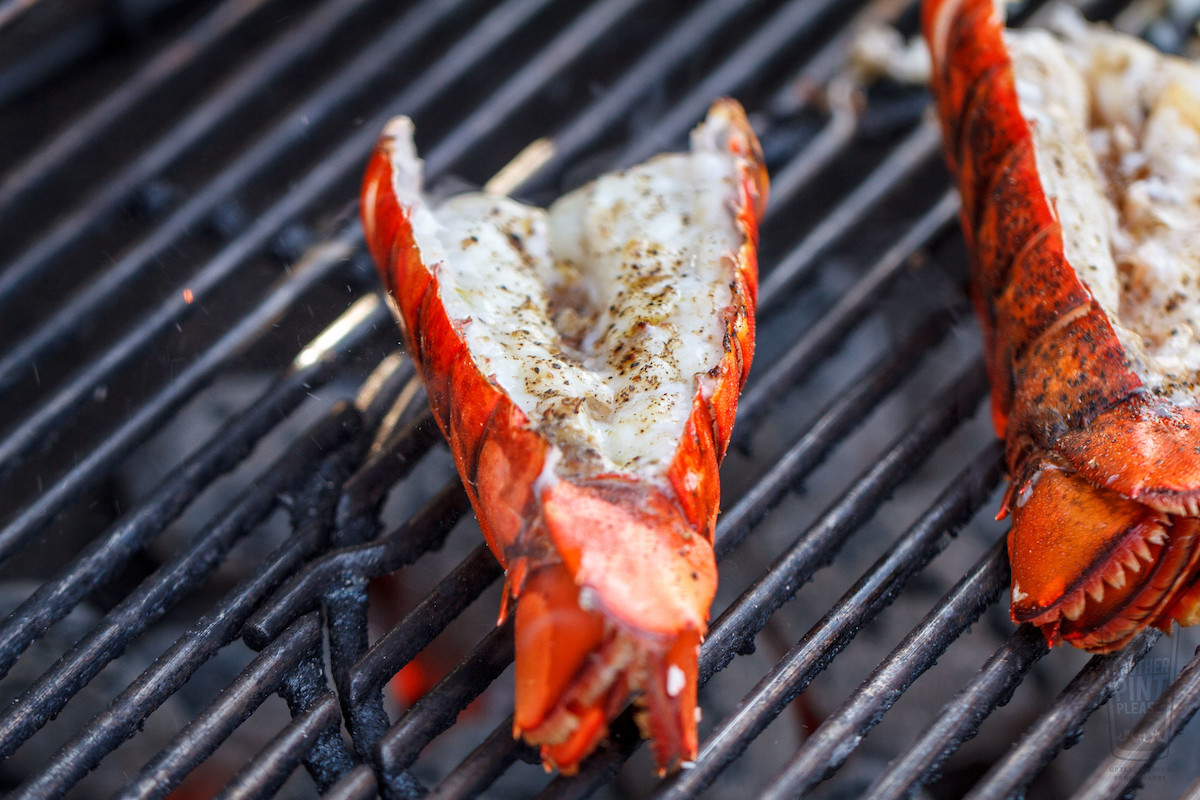 close up of two lobster tails on a grill. Pier Market grills seafood daily on San Francisco's Pier 39.