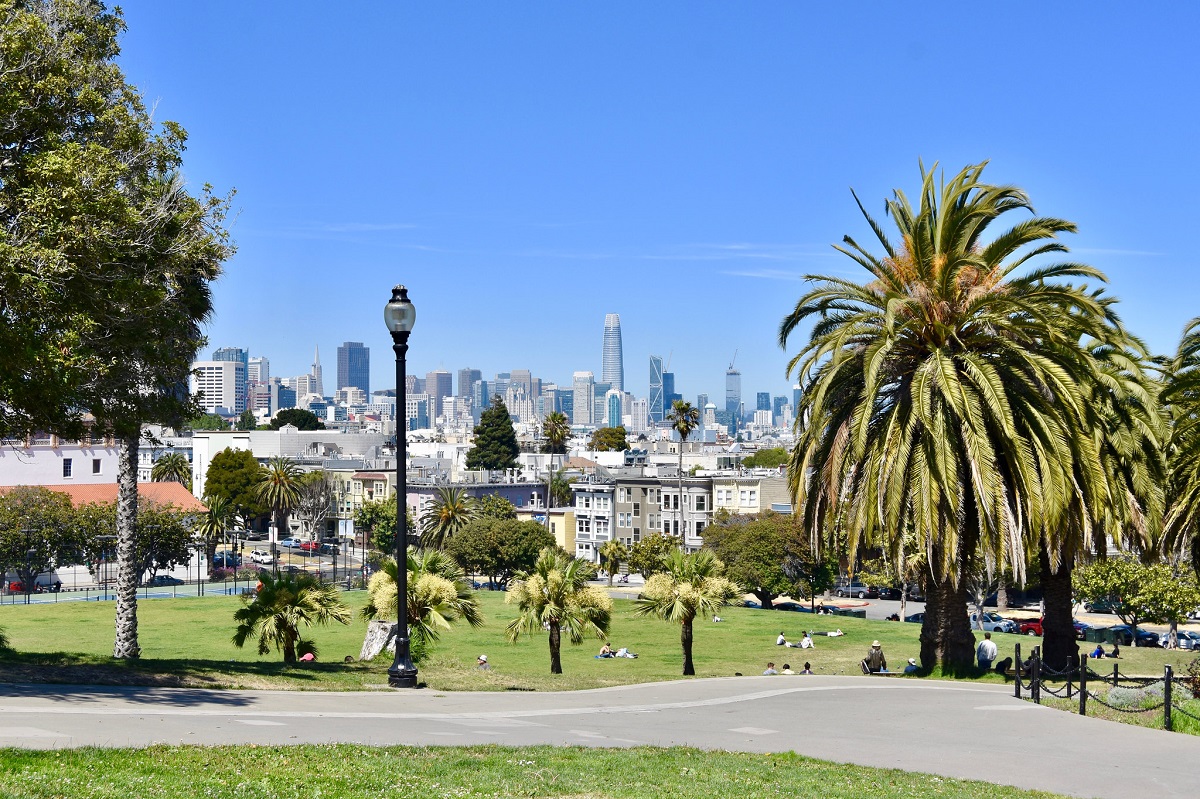 Mission Dolores Park in san francisco on a sunny day with lamps and trees