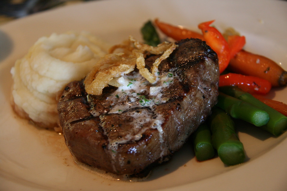 Close up of a grilled steak with mashed potatoes and veggies at Harris Inn and Restaurant