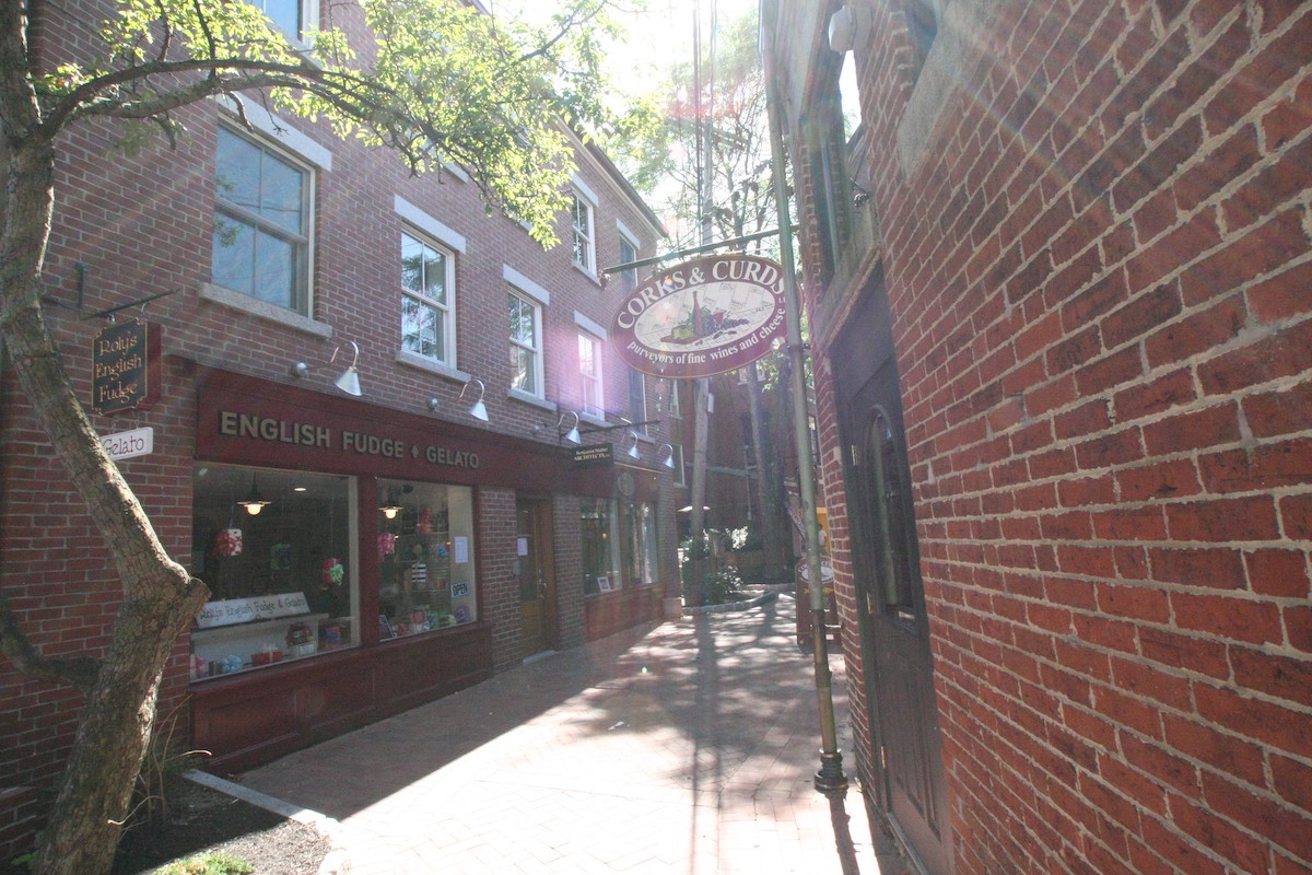 A quaint brick street lined with brick buildings in Portsmouth, New Hampshire, a lovely day trip location from Boston.