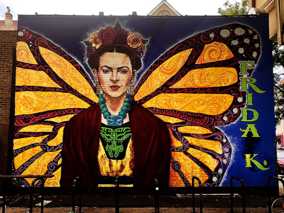 a large mural of the Mexican artist Frida Kahlo with butterfly wings