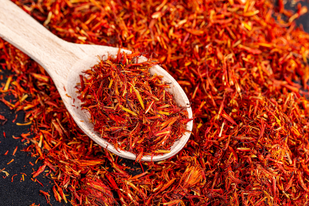 Brightly colored saffron in a wooden spoon