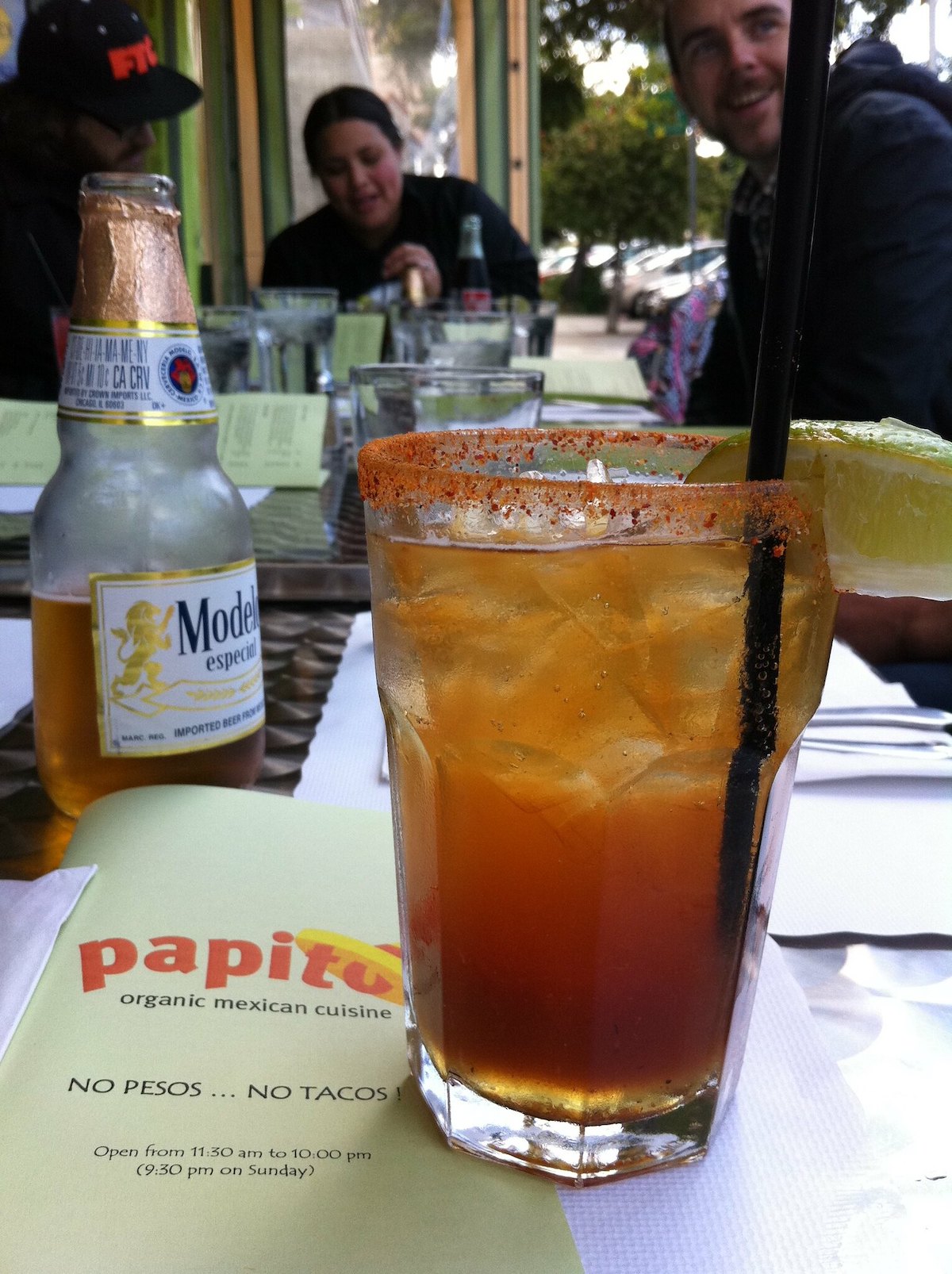A michelada cocktail with a chili-salted rim and lime