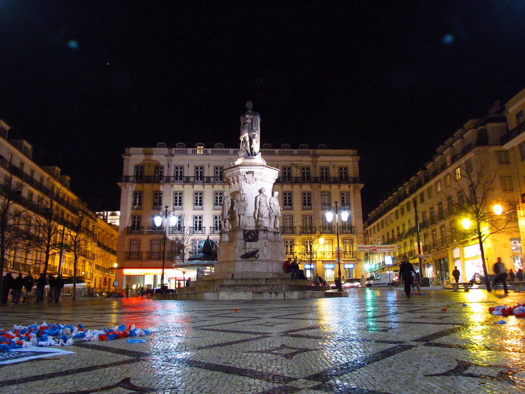 Largo do Chiado square in Lisbon, Portugal at night with statue and colored lights