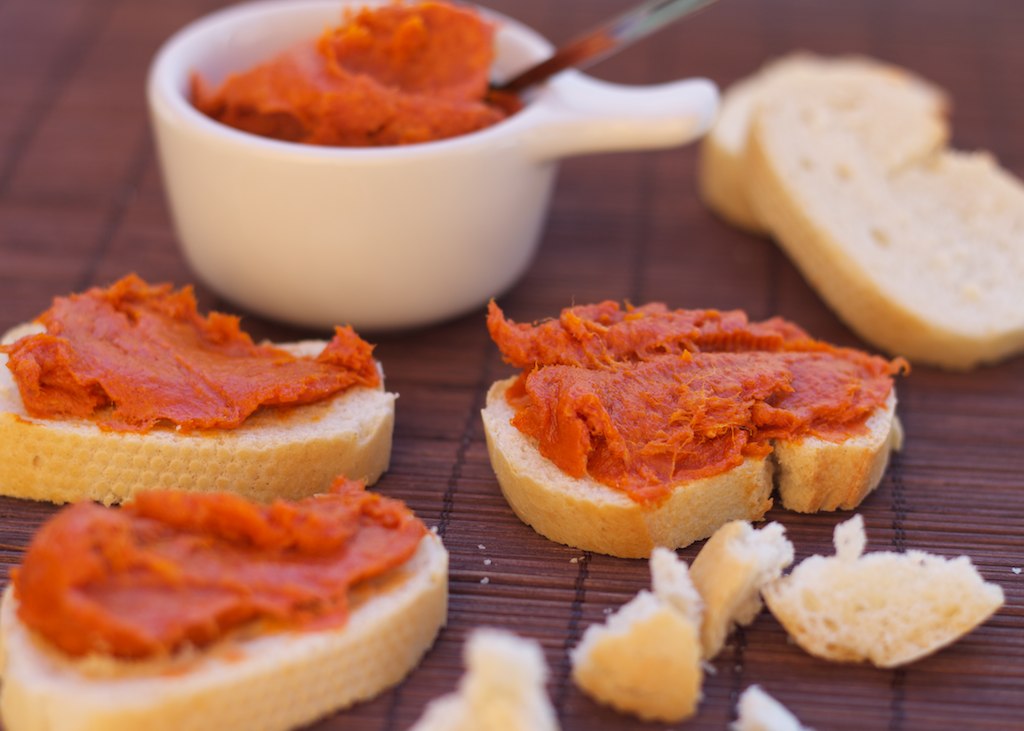 Pieces of toast topped with red sobrasada