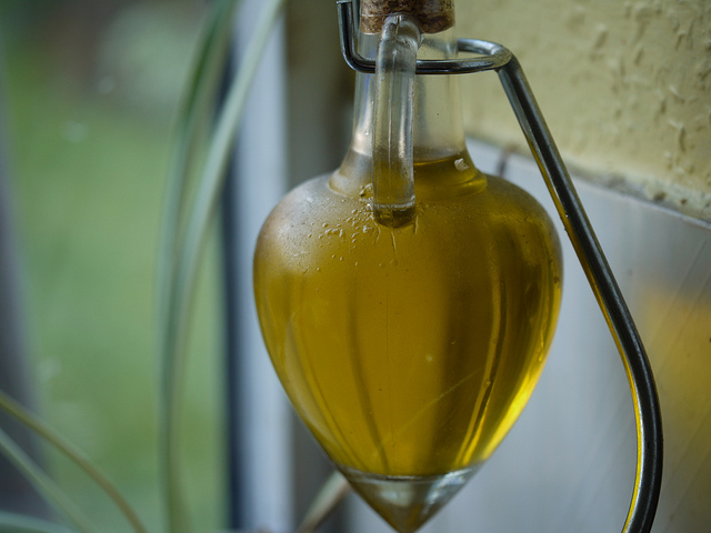An onate bottle of olive oil, displaying it's rich golden color, conveys exactly why Romans referred to olive oil as 'liquid gold'