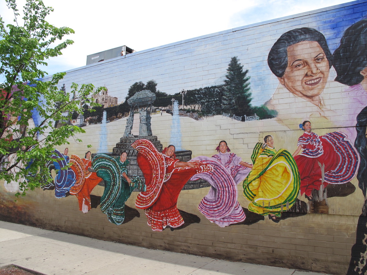 a color mural of women dancing wearing Jalisco dresses