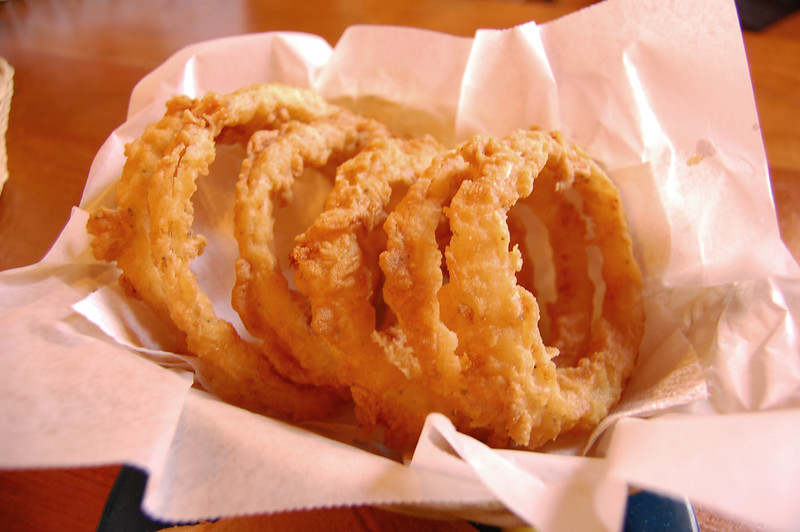 A basket full of fried onion rings