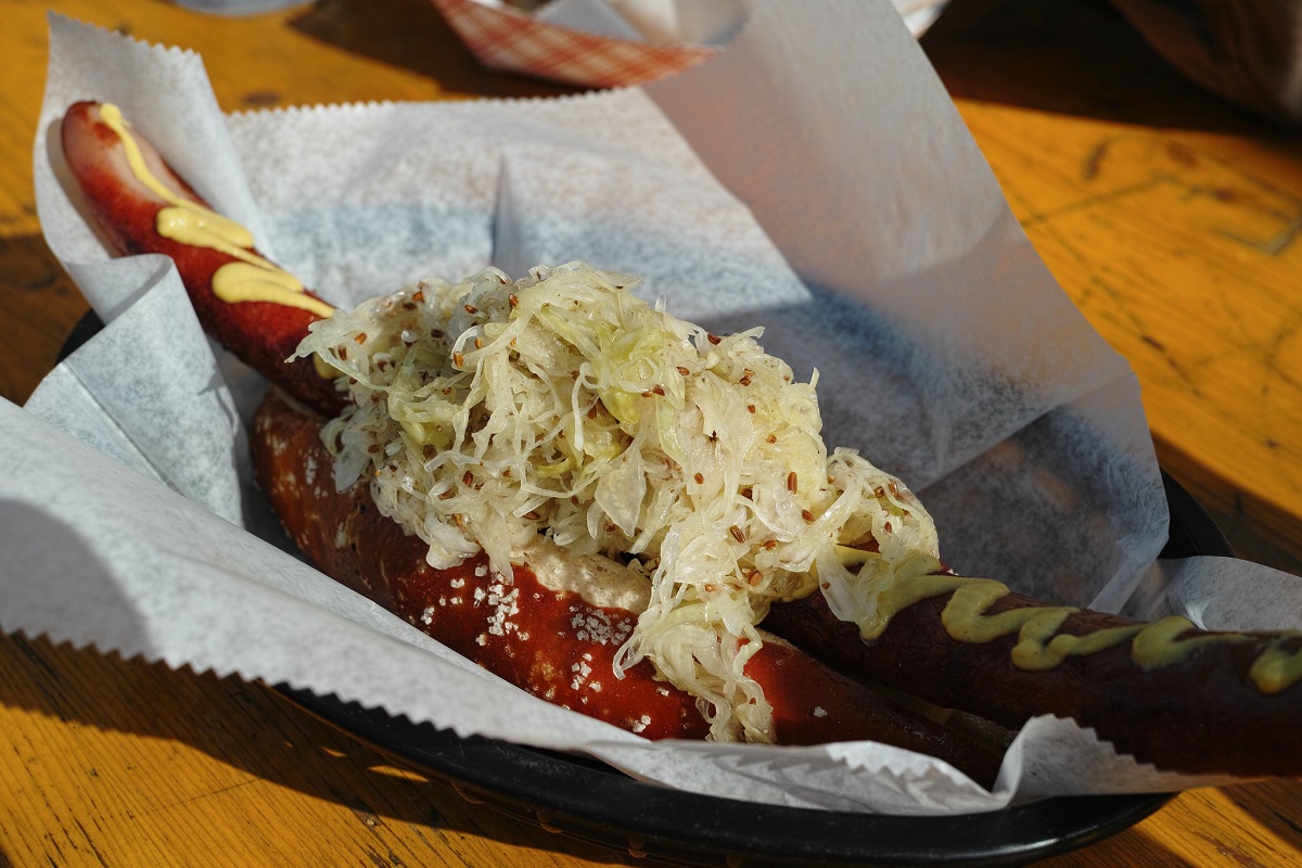 Frankfurter or hot dog topped with saurkraut outside at a pub in San Francisco