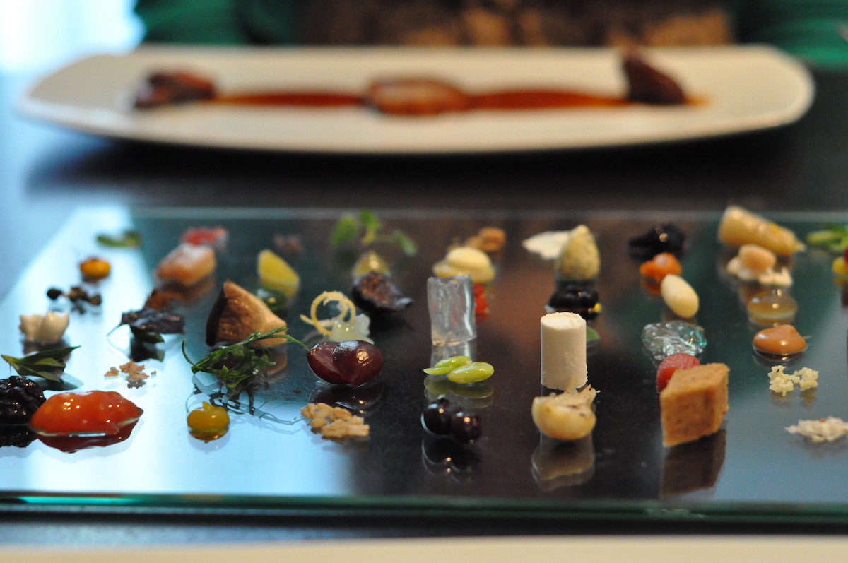 Close up of a dish at Alinea, a restaurant in Chicago, with dozens of tiny bites