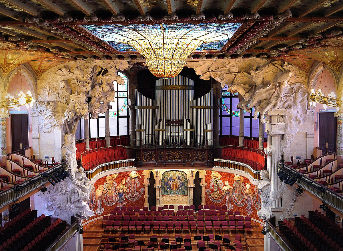 Interior - Palau de la Musica de Catalana in Barcelona with chairs, stage, and chandelier
