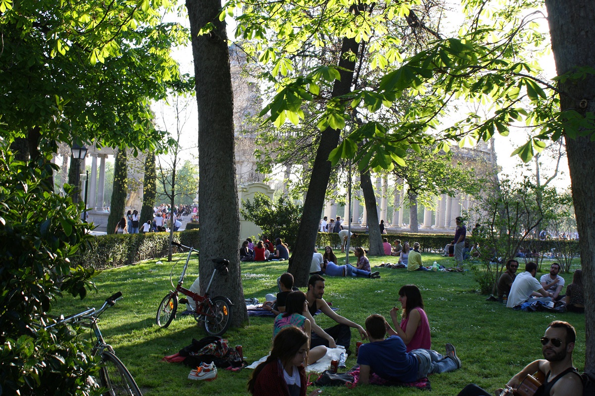 Groups of picnic revelers enjoy a lazy afternoon in the shade