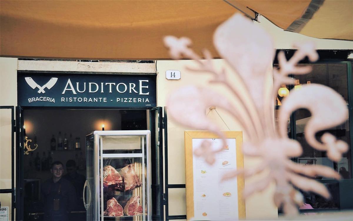 Exterior of a restaurant with a sign above the door reading Auditore Ristorante Braceria
