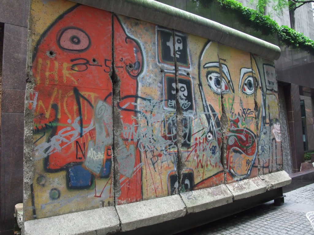 Outdoor murals painted on concrete slabs in dull colors