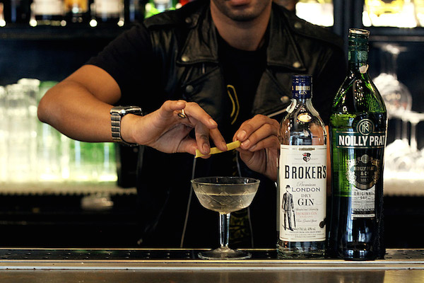 Here, a barman at Freni e Frizioni puts the finishing touch on a Martini