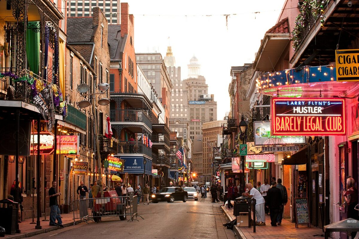 busy New Orleans street with neon lights