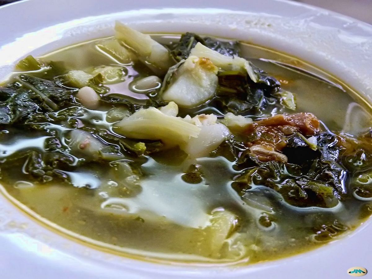 Bowl of caldo gallego (Galician stew) with cabbage, potatoes, and meat