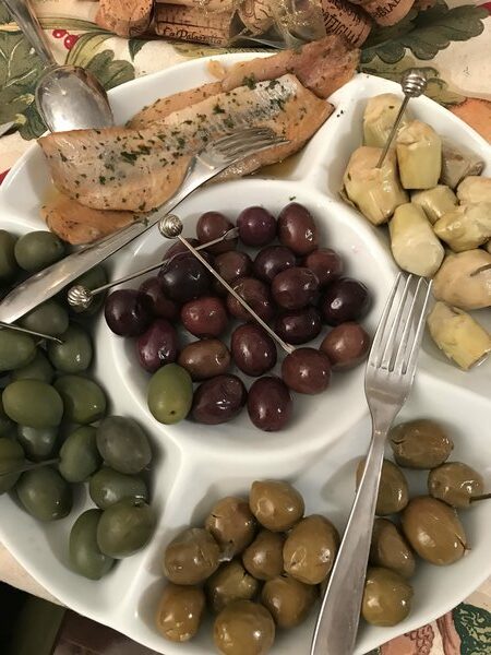 Antipasti platter of olives, marinated artichokes and eel