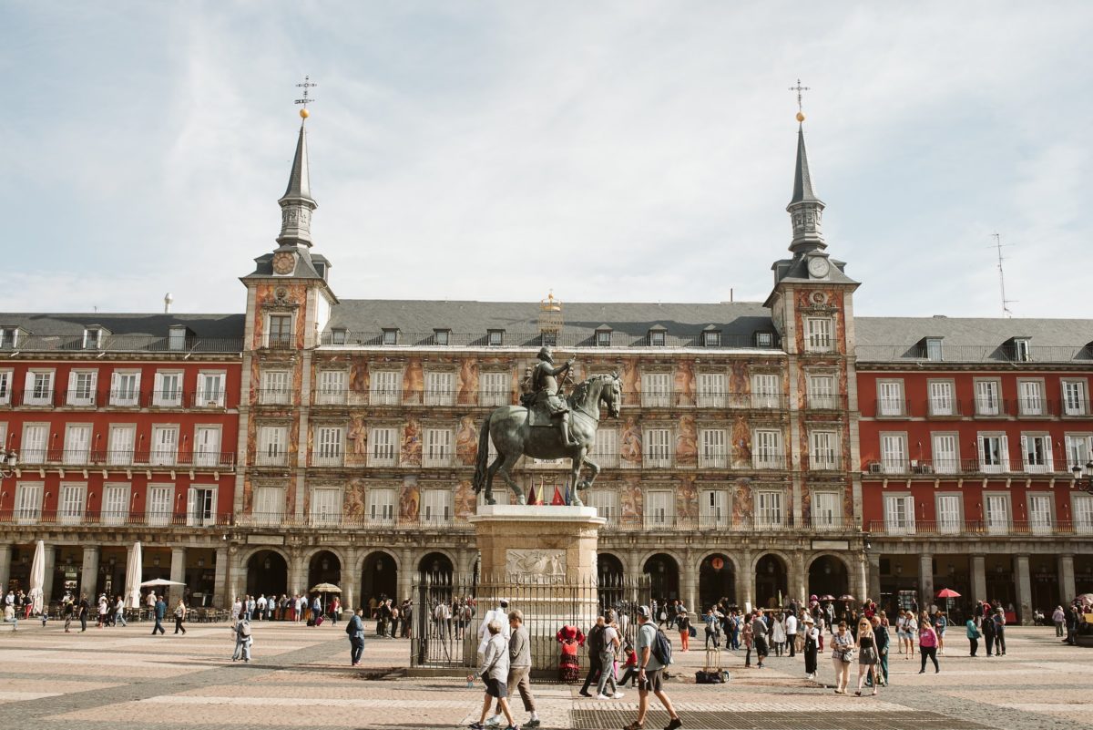 View of Plaza Mayor, a large arcaded square in Madrid, with a statue of a man on horseback