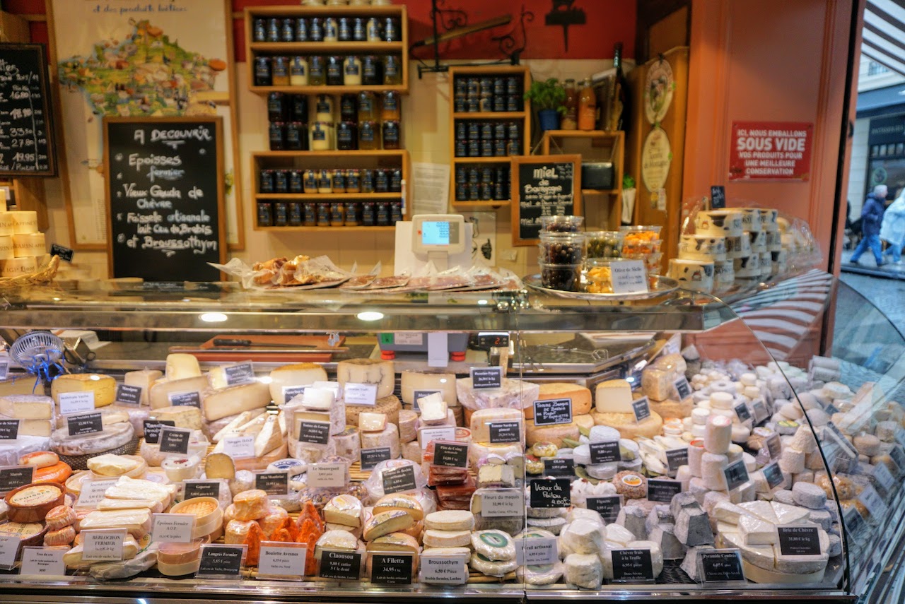 Parisian store counter with french cheeses, fromagerie