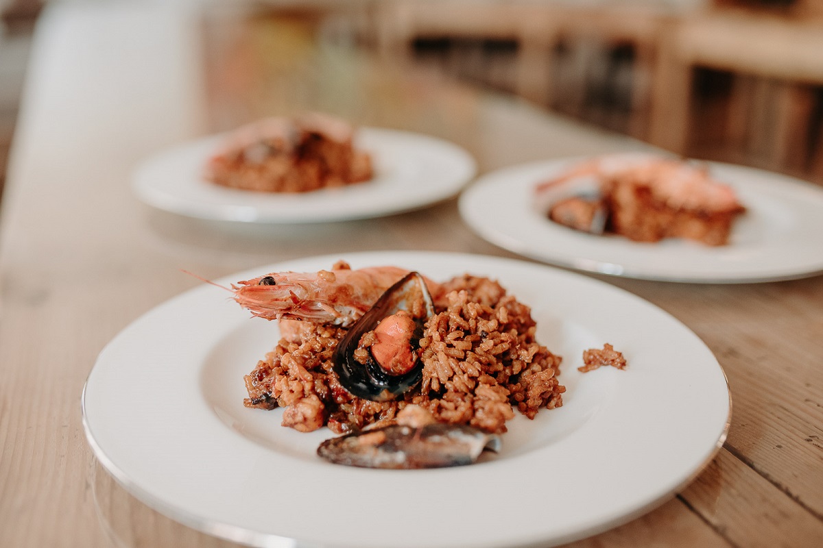 Plate of seafood paella served with a whole shrimp and mussels