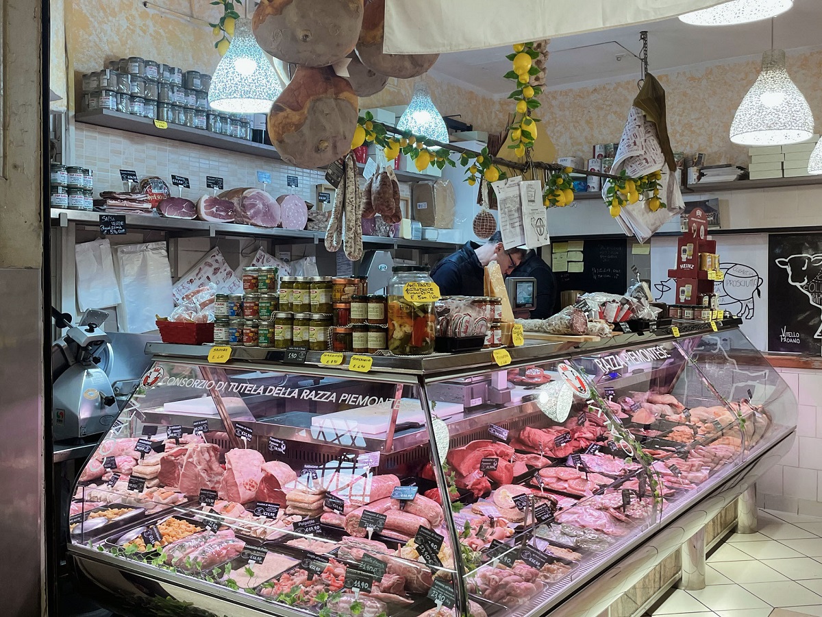Bologna market with prosciutto, mortadella, salami, and other meats