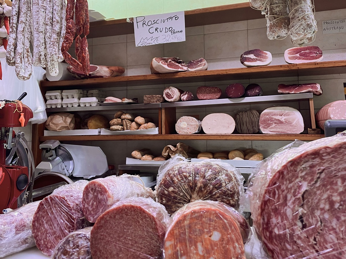 Meat shop or stand in bolgona with meat like salami, prosciutto, and mortadella