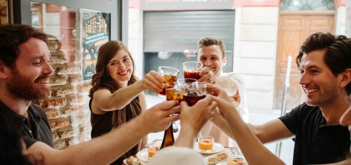 a group doing a cheers in a restaurant