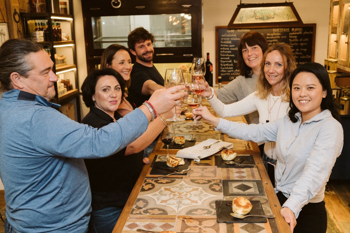 A group of people raise their wine glasses for a toast
