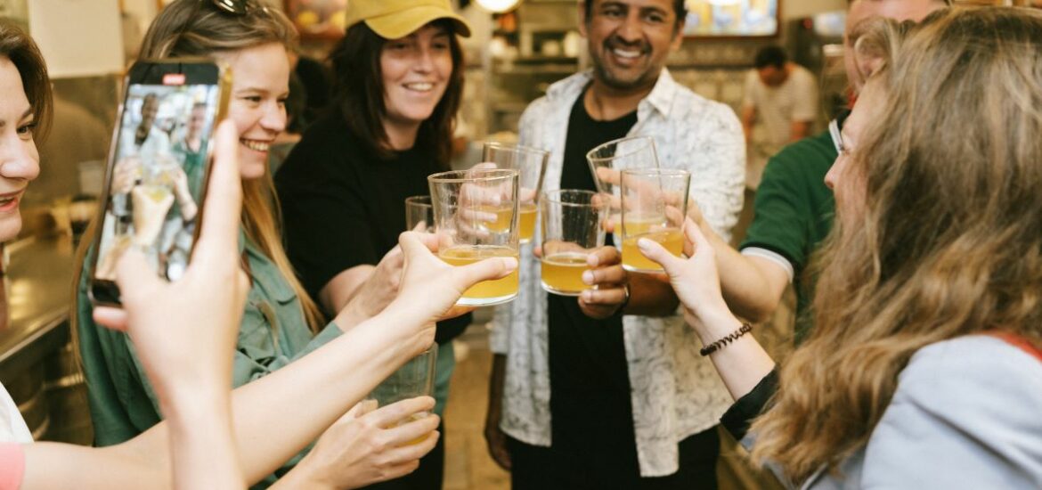 A group takes a moment to cheers with cider while on a food tour in San Sebastian