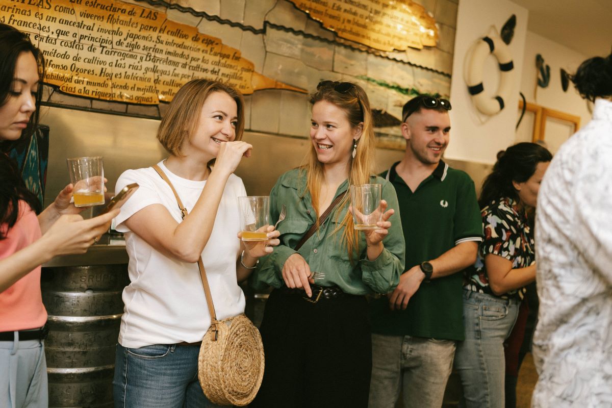 A group mingles inside a bar while on a food tour in San Sebastian
