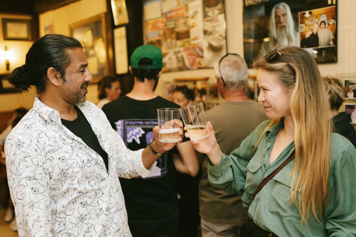 Two guests have a cheers with cider while on a food tour in San Sebastian