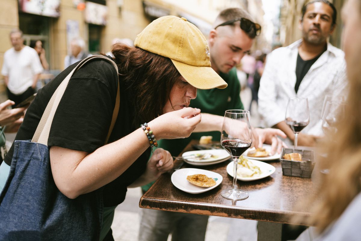 A guest samples food during a food tour in San Sebastian
