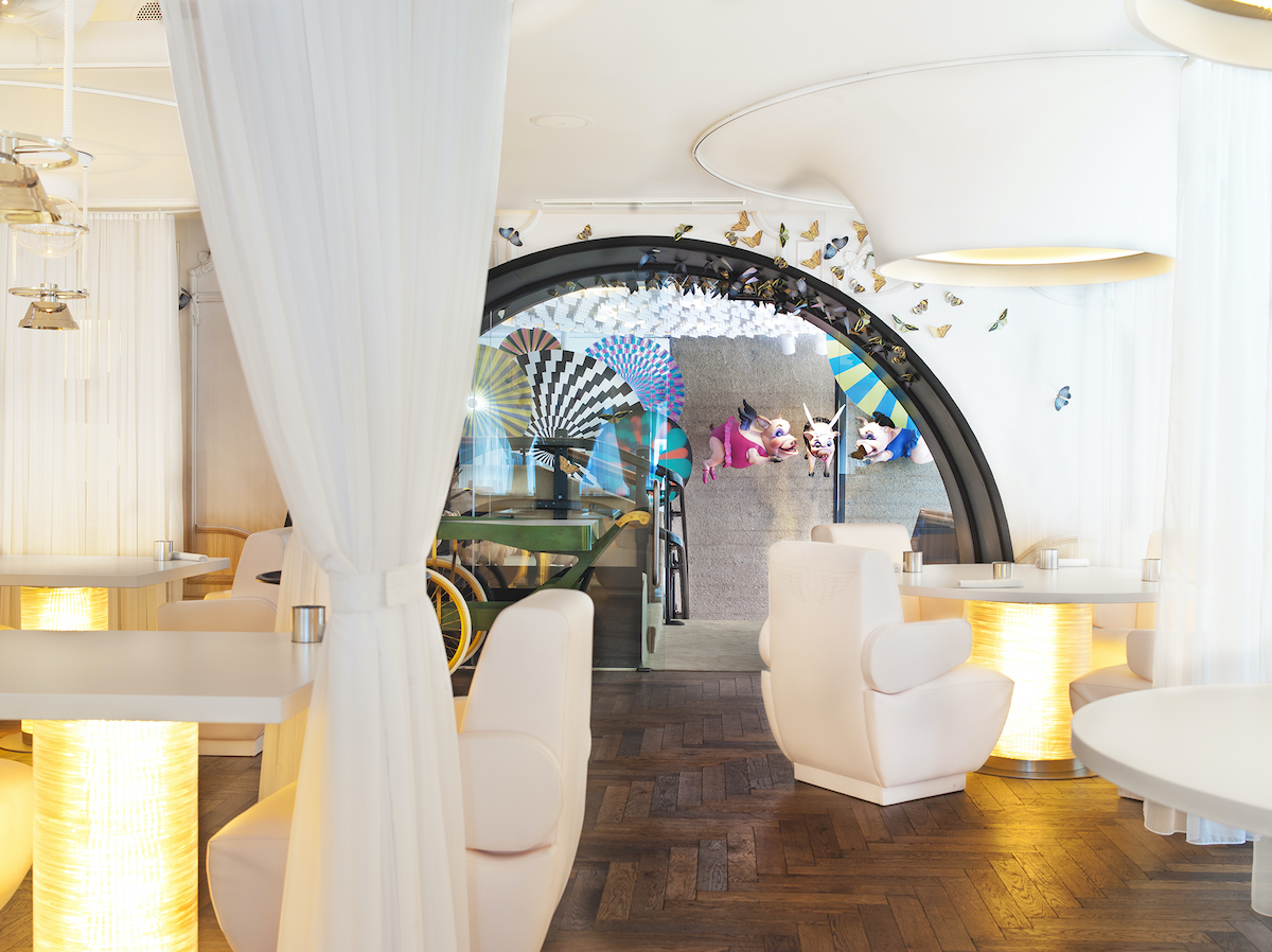 Dining space at DiverXO restaurant in Madrid decorated in white with colorful accents